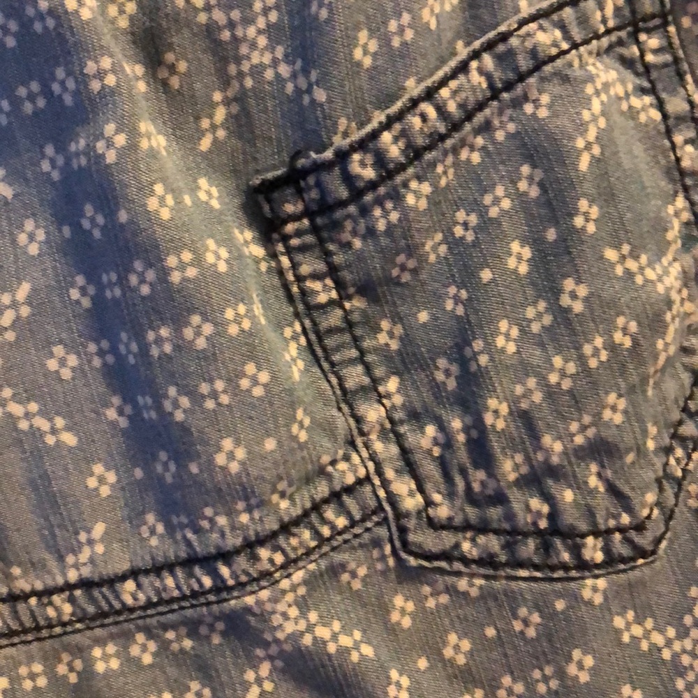 Light denim tank with pocket detail.